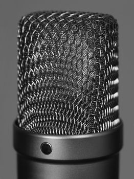 Macro abstract photo of a large diaphragm studio microphone. Shallow depth of field.