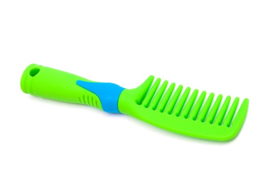 green plastic comb on a white background