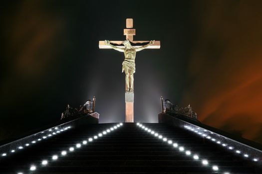 Statue of the crucifixion at night. Dniprodzerzhyns'k, Ukraine.