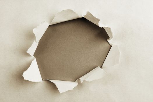 Hole ripped in paper, space for copy