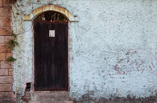 Rusty old door in backyard, Asia