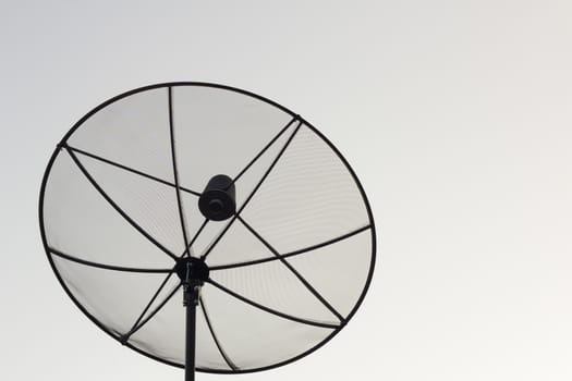 Black antenna communication satellite dish over white sky without cloud