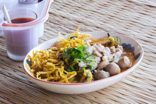Thai noodles with seasoning on a Thai traditional mat