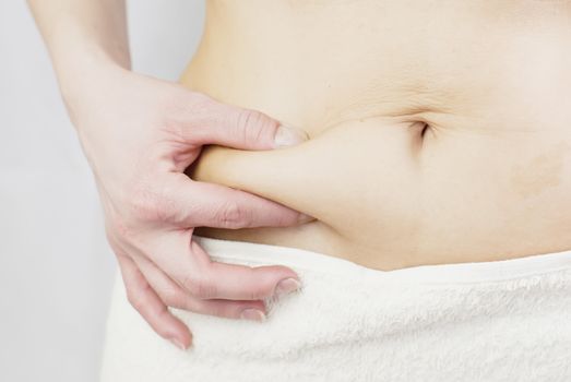 young woman holding her skin for cellulite check