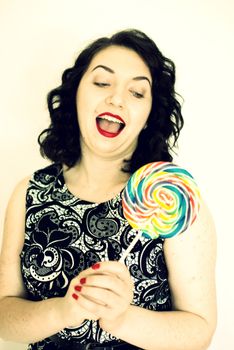 beautiful retro girls portrait with colorful lollipop