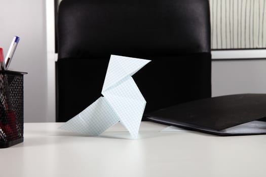 worker wasting time with origami