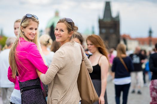 Two pretty, young women sightseeing in Prague historic center