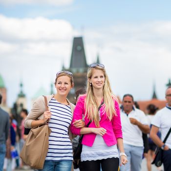 Two pretty, young women sightseeing in Prague historic center