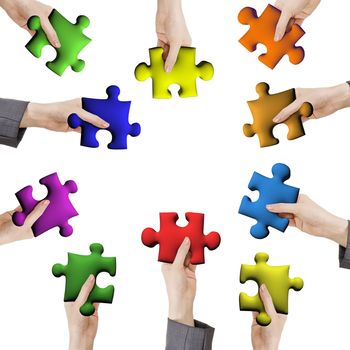 Concept of help or working together, hands holding various color puzzle pieces on white background.