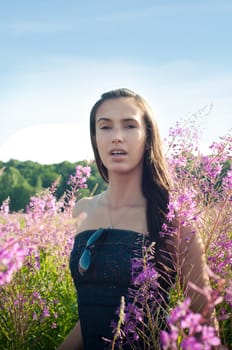 Outdoor shot of beautiful brunette woman with long hair