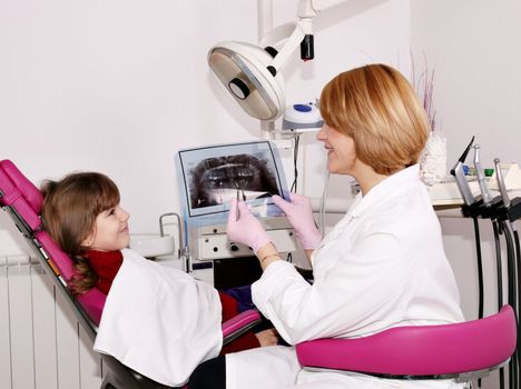 dentist showing x-ray to a little girl 