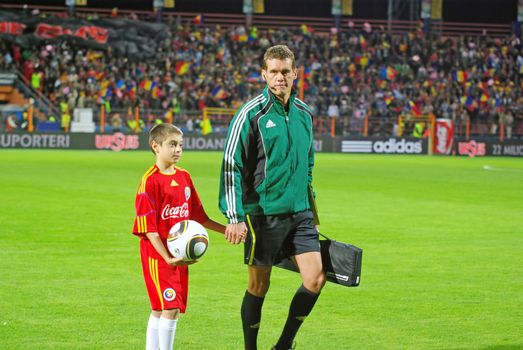 PIATRA NEAMT, ROMANIA: SEPTEMBER 3 - The referee Robert Schorgenhofer (AUT) at beginning of the match between Romania and Albania (Qualifying Round, UEFA European Championship) on September 3, 2010 in Piatra Neamt, Romania