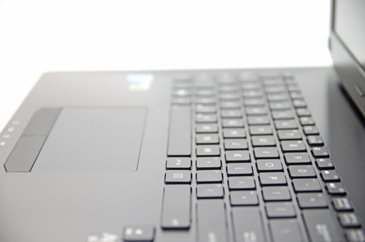 Black laptop keyboard and touchpad surface