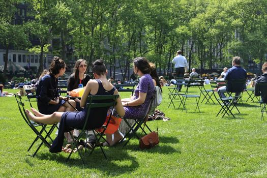 NEW YORK, USA - MAY 16: People enjoying a nice day in Bryant Park on May 16, 2013 in New York City, NY. Bryant Park is a 9,603 acre privately managed park in the center of Manhattan.