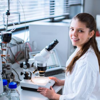 Portrait of a female chemistry student carrying out research in a chemistry lab (color toned image; shallow DOF)