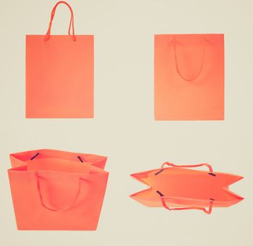 Vintage retro looking Set of orange shopping bags isolated over white background