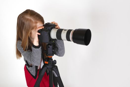 Young girl using digital camera as a photographer