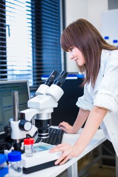 Portrait of a female researcher doing research in a lab (shallow DOF; color toned image)