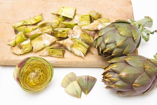 Artichokes cut on cutting board and white background