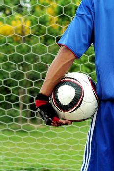 Football goalkeeper holding them in hand.