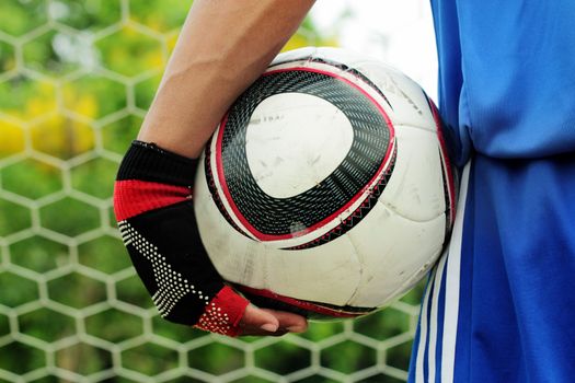 soccer player in front of goal with ball.