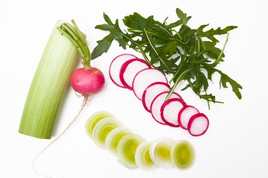 Leek and radish and arugula on a white background