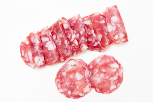 Slices of salami on white background