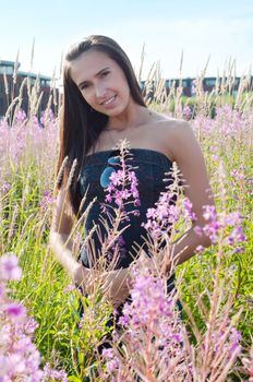 Outdoor shot of beautiful brunette woman with long hair