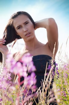 Outdoor shot of beautiful brunette woman with long hair