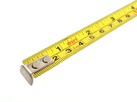 Close up photo of a yellow tape measure on a white background.