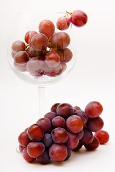 bunch of red grapes in a wine glass