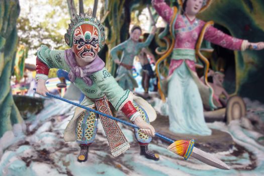 SINGAPORE - FEBRUARY 1, 2014: Ancient Chinese Warrior with Painted Face holding spear at Haw Par Villa Theme Park. This theme park contains over 1,000 statues and 150 giant dioramas depicting scenes from Chinese mythology, folklore, legends, and history.