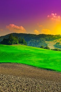 Plowed Sloping Hills of Tuscany at Sunset