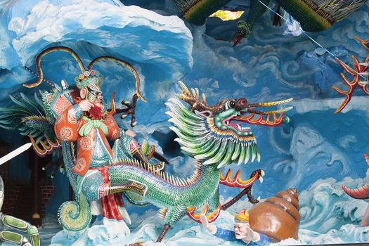 SINGAPORE - FEBRUARY 1, 2014: Neptune Riding Dragon in the Eight Immortals Invading Neptune Palace Diorama at Haw Par Villa Theme Park. This theme park contains over 1,000 statues and 150 giant dioramas depicting scenes from Chinese mythology, folklore, legends, and history.