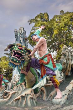 SINGAPORE - FEBRUARY 1, 2014: Ancient Chinese Warrior Wu Song Slaying Tiger Statue Diorama at Haw Par Villa Theme Park. This theme park contains over 1,000 statues and 150 giant dioramas depicting scenes from Chinese mythology, folklore, legends, and history.