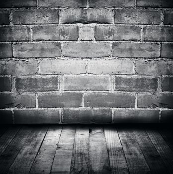 Wooden floorboards and brick wall