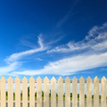 White fences with blue sky