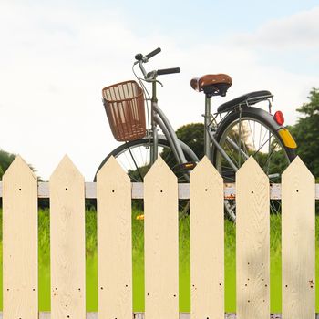 White fences in the garden with bicycles