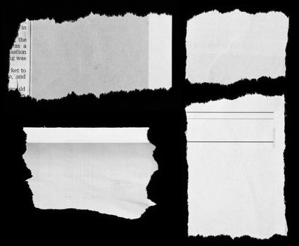Pieces of torn paper on black. Copy space 