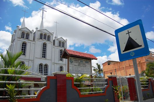 Christian church with metal plate road sign, Indonesia