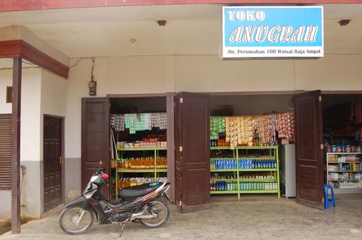 Motorcycle at store entrance Indonesian town