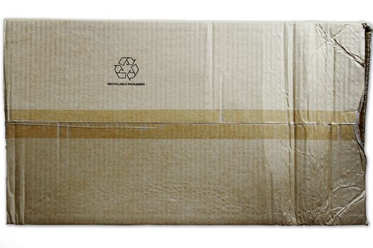 Closeup of packing tape and recycling symbol on cardboard box 