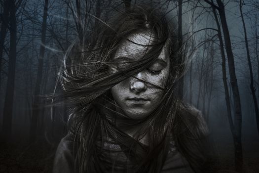 beautiful girl with long hair in dark forest, developing