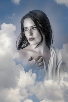 Sensual, Beautiful woman in clouds, mithology concept. Brunette with long hair and white dress.