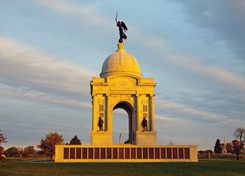 The Pennsylvania Monument in Gettysburg National Military Park illuminated with early morning sunlight.
