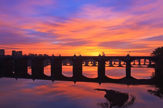 A colorful sunrise over the many old bridges crossing the Susquehanna River in Harrisburg, Pennsylvania, USA.