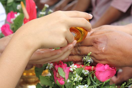 Thai people celebrate Songkran (new year / water festival: 13 April) by giving garlands to their seniors and asked for blessings