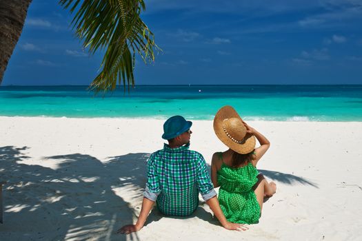 Couple in green on a tropical beach at Maldives