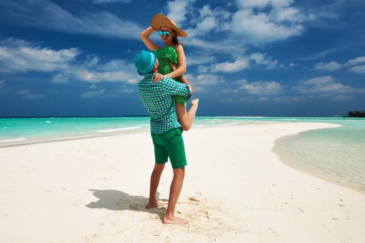 Couple in green on a tropical beach at Maldives