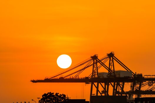 Crane in the industrial port on sunset background